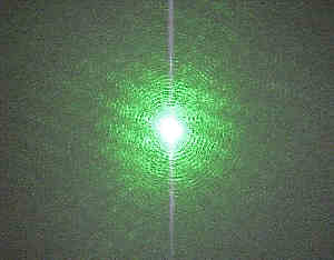 The green laser beam scattered from a surface.